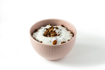 Chocolate granola with yogurt . Top view of a ceramic bowl with chocolate granola  and yoghurt on the white background . Muesli isolated , close-up . 