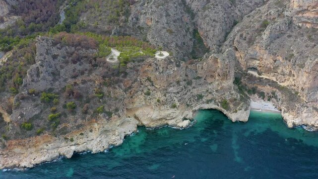 Aerial view of the wonderful Cala del Moraig and Cala de los Tiestos, located between the beautiful cliffs of the town of Benitachell, in the Mediterranean province of Alicante, Spain.