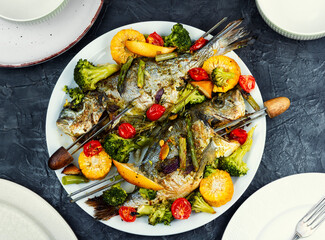 Roasted dorada fish with vegetables.