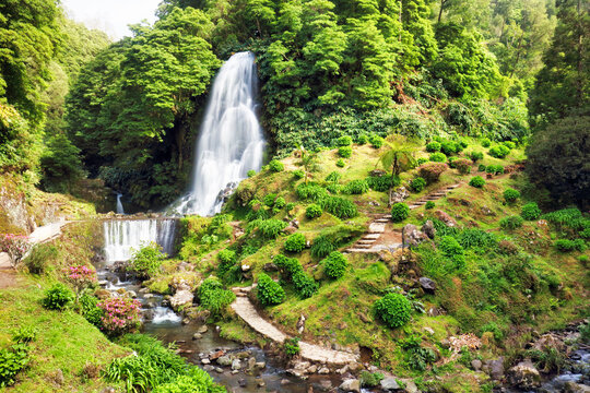 Waterfall at Ribeira dos Caldeir&otilde;es in Nordeste with tourists, Sao Miguel island in the Azores.