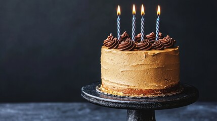 Glowing birthday cake with lit candles in a dark room creating a festive and warm atmosphere for celebration