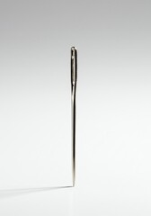 Single Sewing Needle on White Background Close-up