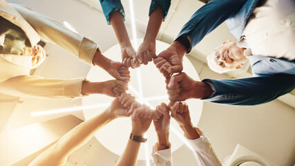 Below, fist bump and hands of business people in office for teamwork, collaboration and solidarity....