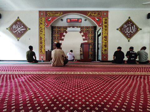 Muslim, prayer and mosque with a spiritual man group praying together during fajr, dhuhr or asr, otherwise maghrib or ishaa. Salah, worship and pray.
