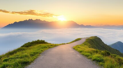 A winding path leads to a breathtaking view of a sunrise over a mountain range.