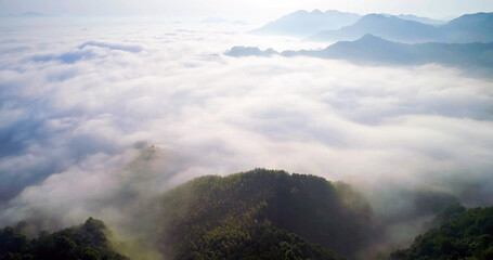 Aerial view of sea of clouds over mountain landscape, dreamy nature scenery