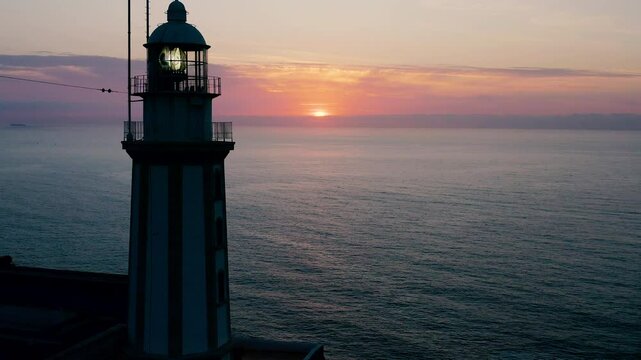 Aerial viewof a beautiful sunrise over the sea horizon, in the lighthouse of La Nao Cape, Alicante, Spain.