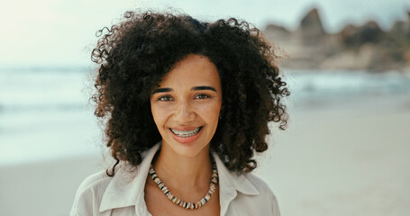 Portrait, travel and happy woman at sea for holiday, vacation and relax outdoor for adventure. Beach, smile and African person in nature at ocean for summer trip on tropical on island in Mauritius