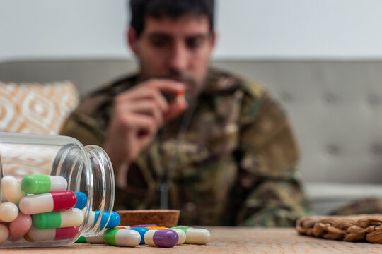 Depressed soldier taking pills for post-traumatic stress disorder