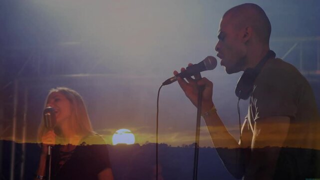 musical duo performing on sunset stage with vintage microphones and lighting for music promotion