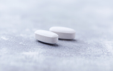Amino acids tablets on wooden background. Soft focus. Close up	
