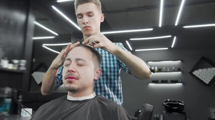 Mature man enjoying a stylish haircut at a modern barbershop