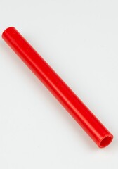 Red Plastic Tube Lying on a White Surface Close-up