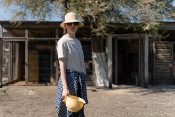 Young Woman Gardener Holding Watering Can on a Sunny Farm Day