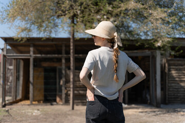 Young Woman Gardener Holding Watering Can on a Sunny Farm Day