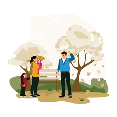 Happy family walking in the park in autumn.