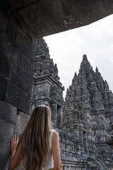Tourist woman admiring prambanan temple complex in yogyakarta, indonesia