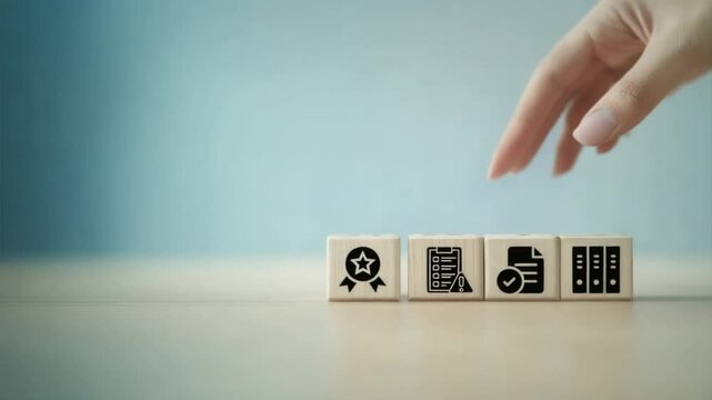 A person hand placed on four wooden blocks with governance risk and compliance icons, symbolizing GRC principles and corporate risk management