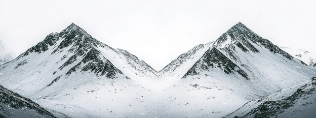 Snow-covered mountain peaks create a serene and majestic winter landscape.