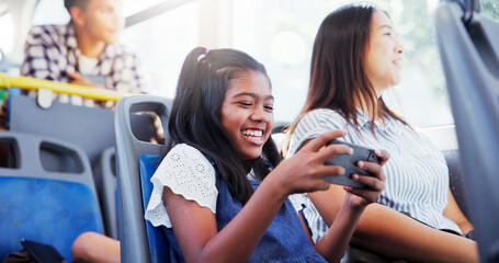 Happy girl, child and watching with phone on bus for entertainment or online streaming in vehicle....
