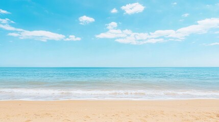Obraz premium A beach scene with a clear blue sky and white clouds.