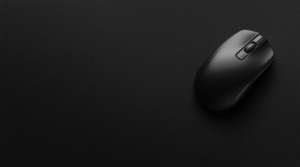 A black computer mouse on a black surface.