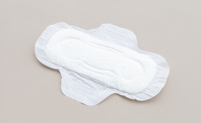 A clean and simple image of a sanitary pad on a neutral-toned background, ideal for wellness and...