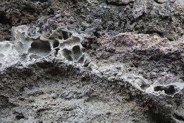 Black lava rock formation with different textures