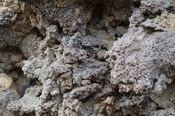 Black lava rock formation with different textures
