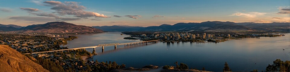 Fototapeta premium Sunset Over Kelowna: Breathtaking Skyline, Okanagan Lake, and R W Bennett Bridge from Knox Mountain in British Columbia, Canada