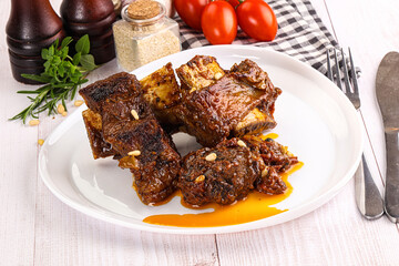 Prepared tasty beef ribs with sauce