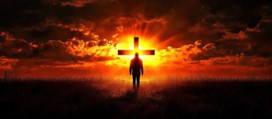 Fototapeta premium Silhouette figure at sunset with cross