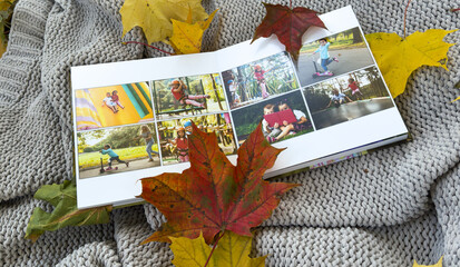 Photobook on the leaves background, closeup of photobook, family photo album