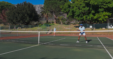 Tennis, sport and mature people with racket, performance and playing of game for exercise, healthy and active. Outdoor, training and athlete with equipment for workout, match or confident for fitness