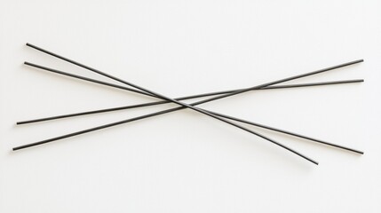 A black wire is twisted into a cross shape.