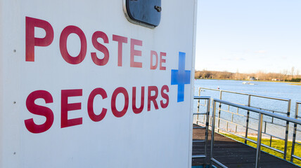 poste de secours french text translated in first aid point sign with blue cross medic signage...