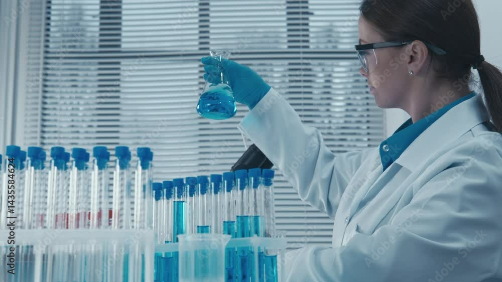 Poster a dedicated scientist in lab gear examines a vibrant blue solution in a flask, surrounded by test tu