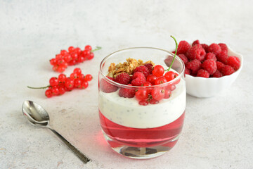 Layered Dessert with Red Berries and Granola in a Glass