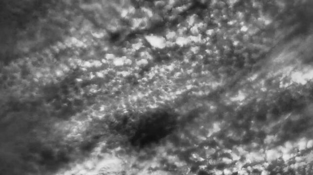 Altocumulus high cumulus heaped cloud stratocumuliform. Globular masses or rolls in layers or patches. Cumuliform stratocumuliform clouds, altocumulus signifies convection. Black and white monochrome