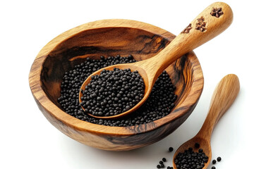 A wooden bowl with black seeds and a spoon with a sp