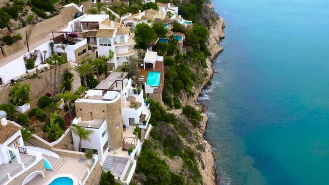Aerial view of the beachs and chalets of Cala Portet in Moraira, Mediterranean Sea, Spain.