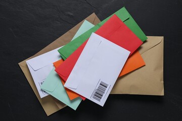 Different paper envelopes on black table, top view. Post office
