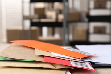 Many different envelopes on table in post office. Space for text