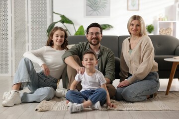 Portrait of happy family on floor at home