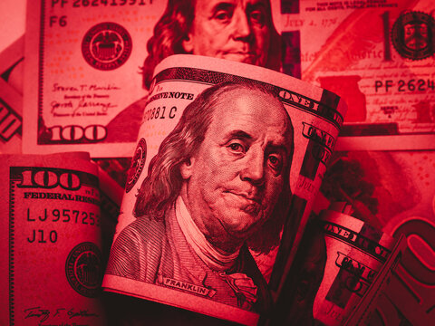 Down stock market, dollar weakens, business financial, inflation, online Investment concept. 100 USA American dollars cash bill banknote with Benjamin Franklin's portrait, red tone background.