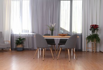 Windows with stylish curtains in living room interior