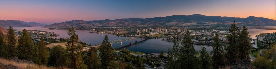 Fototapeta premium Stunning Kelowna Skyline at Sunset: Okanagan Lake and R W Bennett Bridge from Knox Mountain with Vibrant Blue Skies