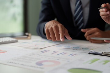 Business Collaboration and Analytics Discussion. Professionals analyzing sales data and statistics...