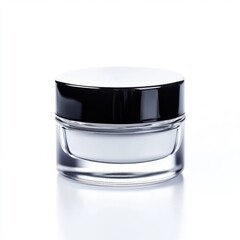 Close up of a small clear jar with white cream and black lid on white