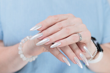 beautiful female hands with long nails light white manicure